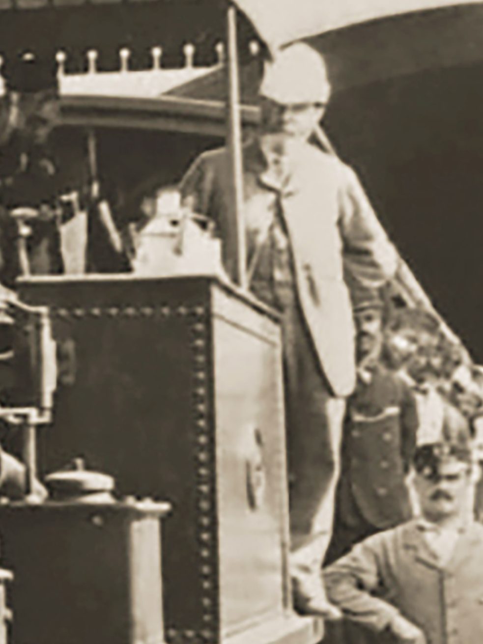 Geneste, again in 1883, on the footplate of one of the engines. His over-coat and pith helmet, early PPE equipment,  identify him as a railway engineer.