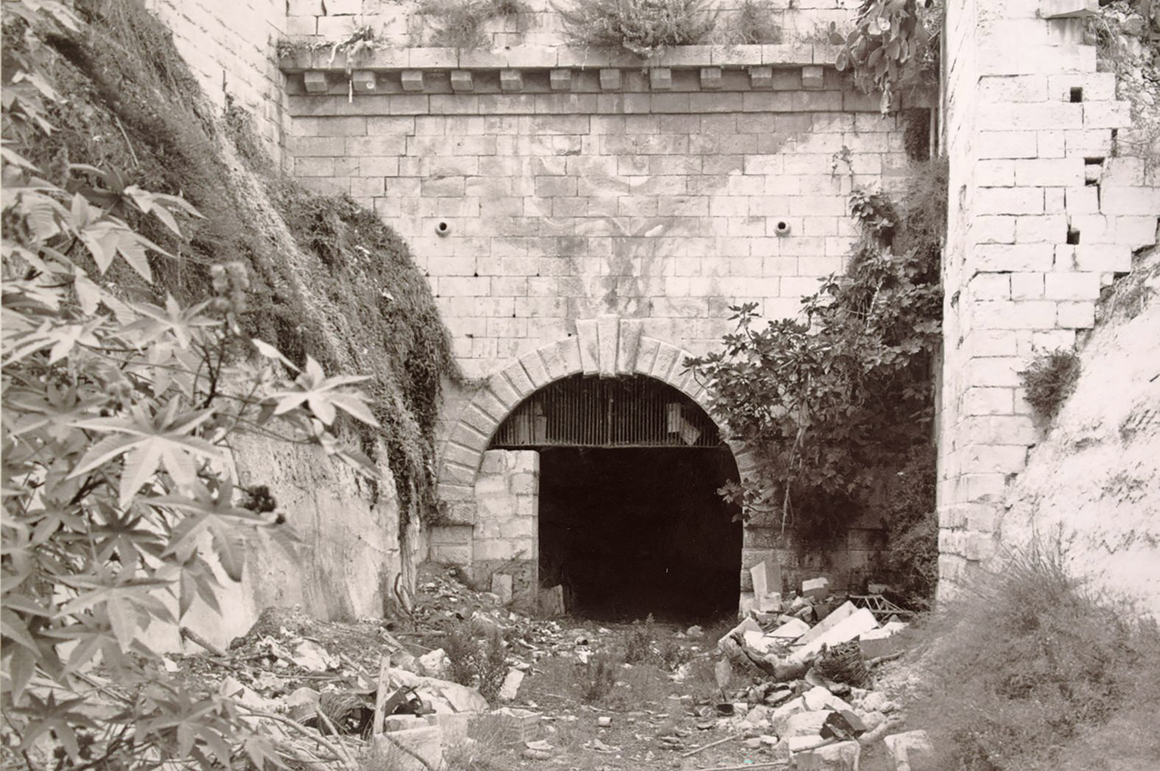 The eastern portal of the Mdina tunnel seen long after the railway closed, but still with smoke stains curling up its face. This was one of a series of photographs taken in 1967 and sold commercially. This end of the tunnel had a similar if more constricted design.