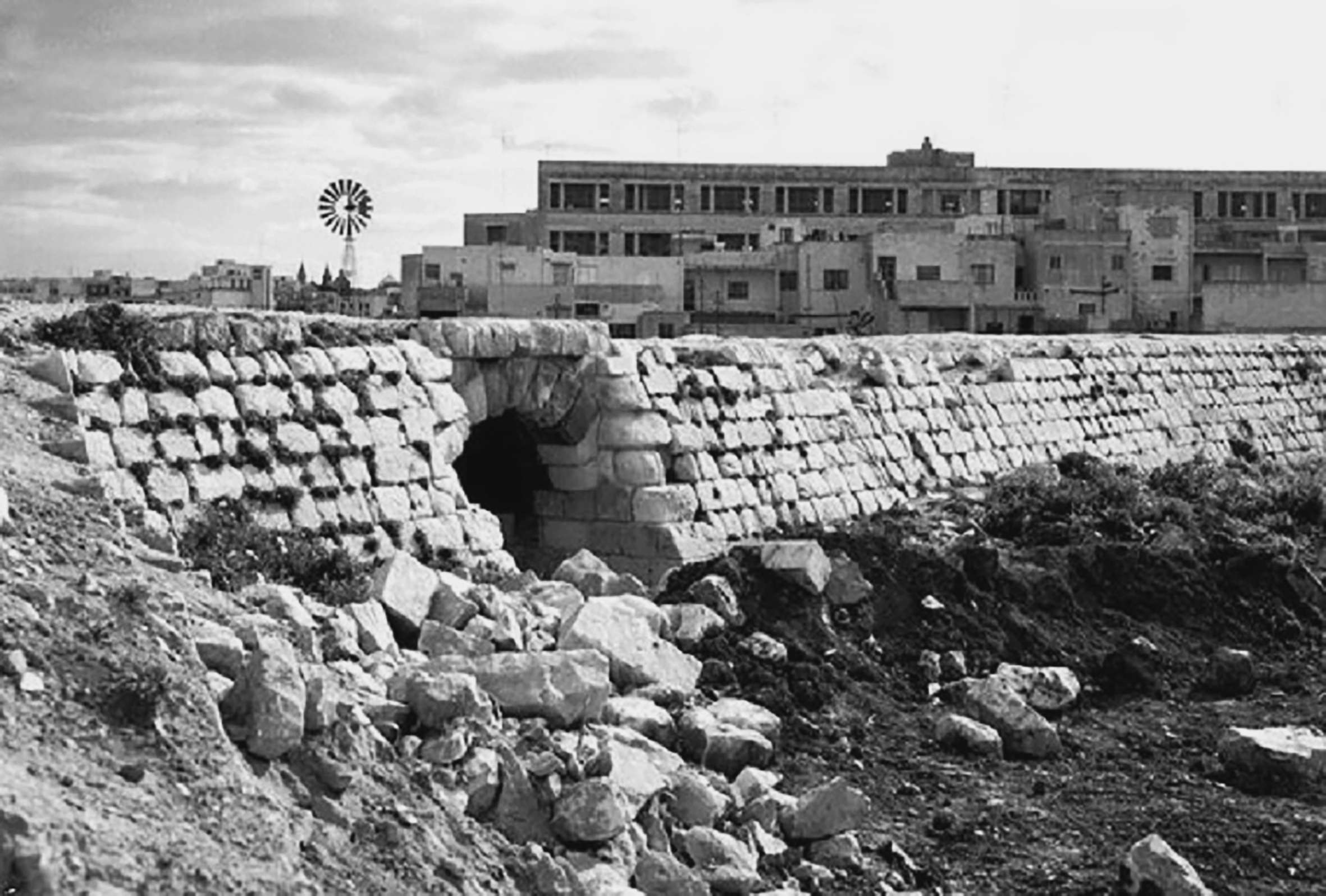 The embankment at the entrance to Msida station in the 1960s. This was the typical character of the embankment structures, with flush coursed stonework and steep revetted walls. The underpass was one of many along the line provided for agricultural use.