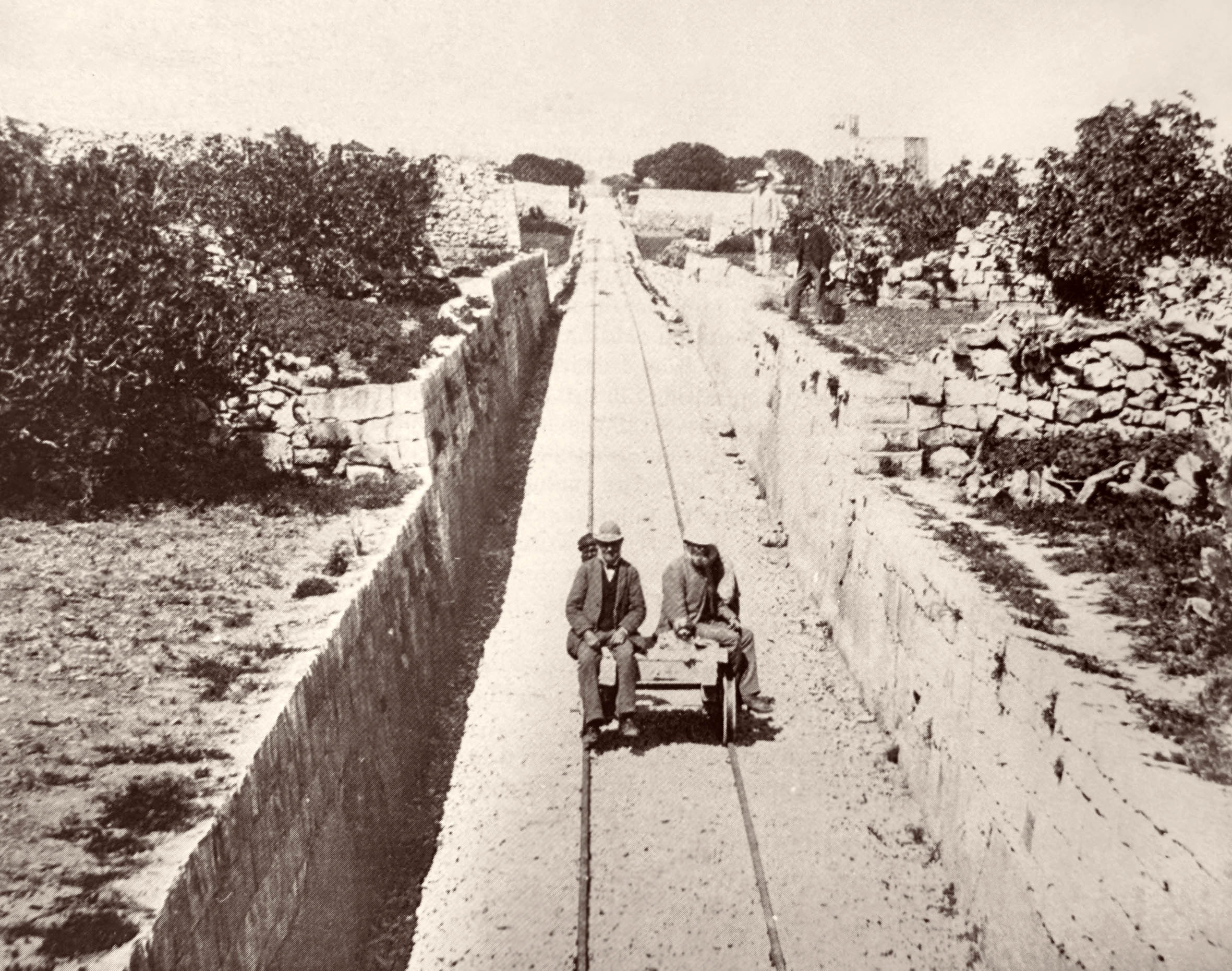 A third view of the cutting at Attard, this one taken from the overbridge seen in the background of the previous two and looking towards Mdina. Frank Geneste sits on the right of the wagon in this view, appearing prominently in most of this series of photographs.