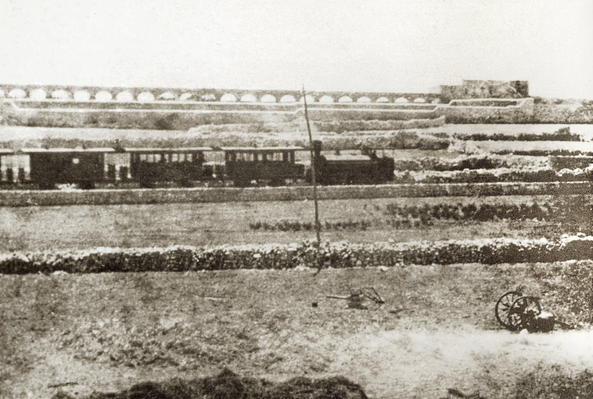 Locomotive No.4 heads up-country near San Antonio station with the Wignacourt Aqueduct as backdrop, probably in the Malta Railway Company's time. This engine's boiler exploded in Floriana tunnel in 1889 and remained in damaged condition at Hamrun for the few months the company remained operational.