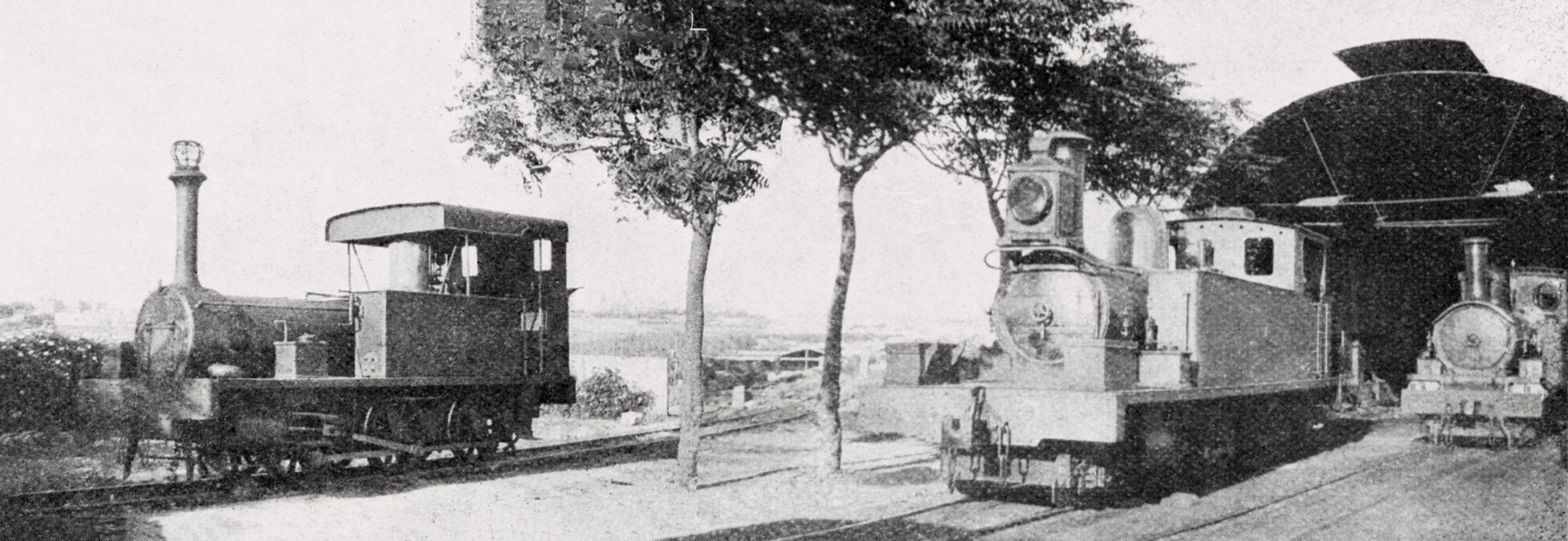 A composite of two photos published in The Locomotive magazine in 1912. The small Manning Wardle engine stands on the siding laid on the alignment of the planned engine and carriage sheds that, by this time, had been abandoned as a plan. The line of trees separating this from the existing shed was part of Buhagiar's planting. The engine shed seen here had been built as the original carriage shed in 1883.