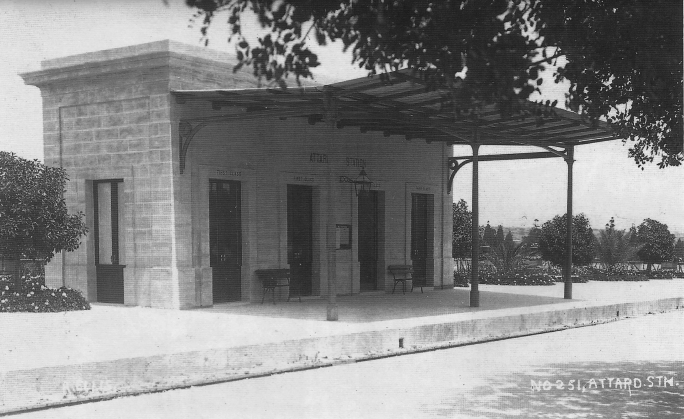 Attard station shortly after rebuilding in 1910. The buildings followed the model set by the earlier stations in their elegant and lofty attitude. The neatly planted gardens are seen either side of the new waiting room building, the boundary wall topped by ornamental urns. The carob trees planted in 1897 still shade the southern platform.