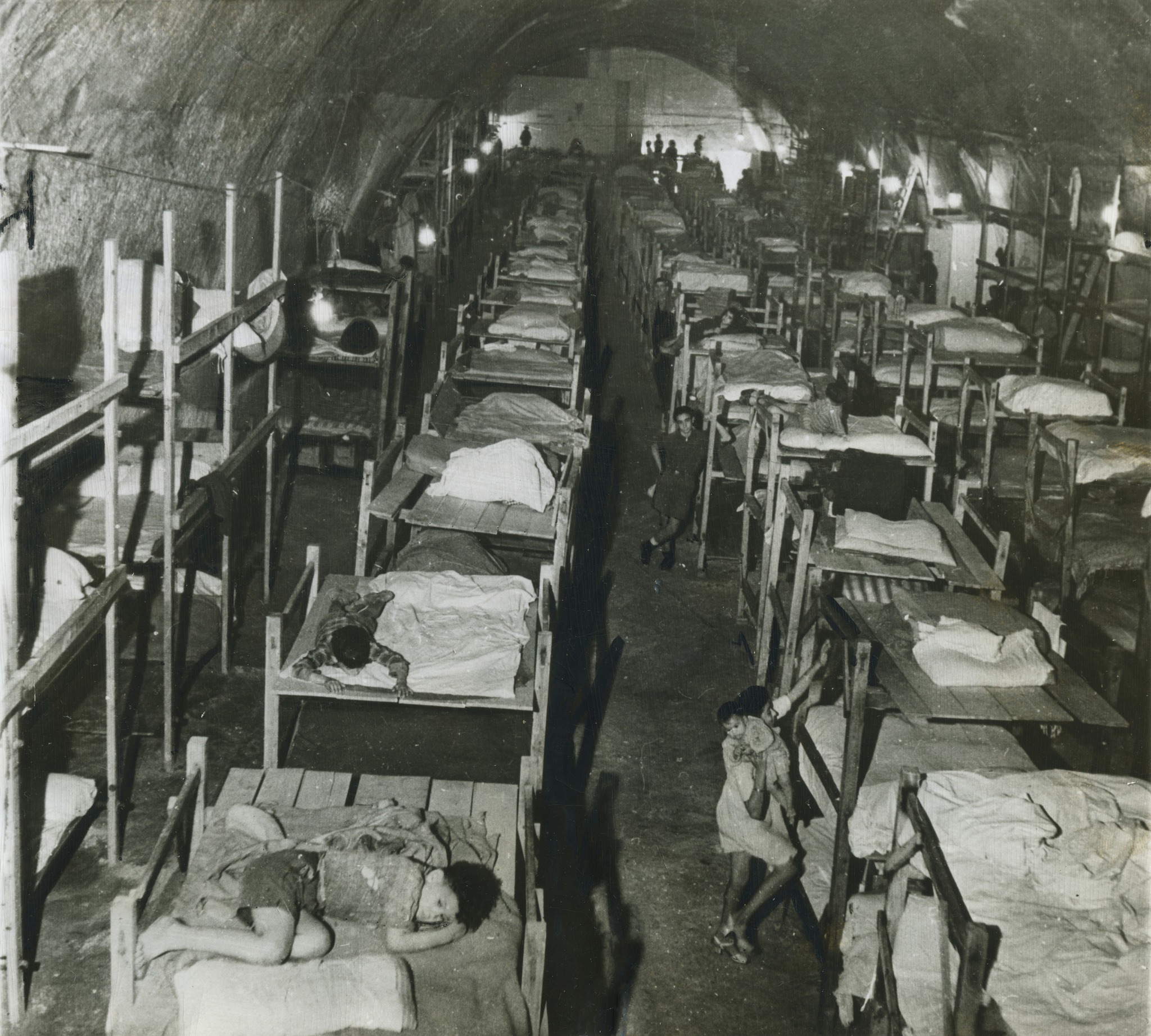 Looking through the cluttered bomb shelter. It looks here as though it's mostly children in residence, suggesting that adults were out at work. When in full use the former station must have been incredibly crowded and noisy.