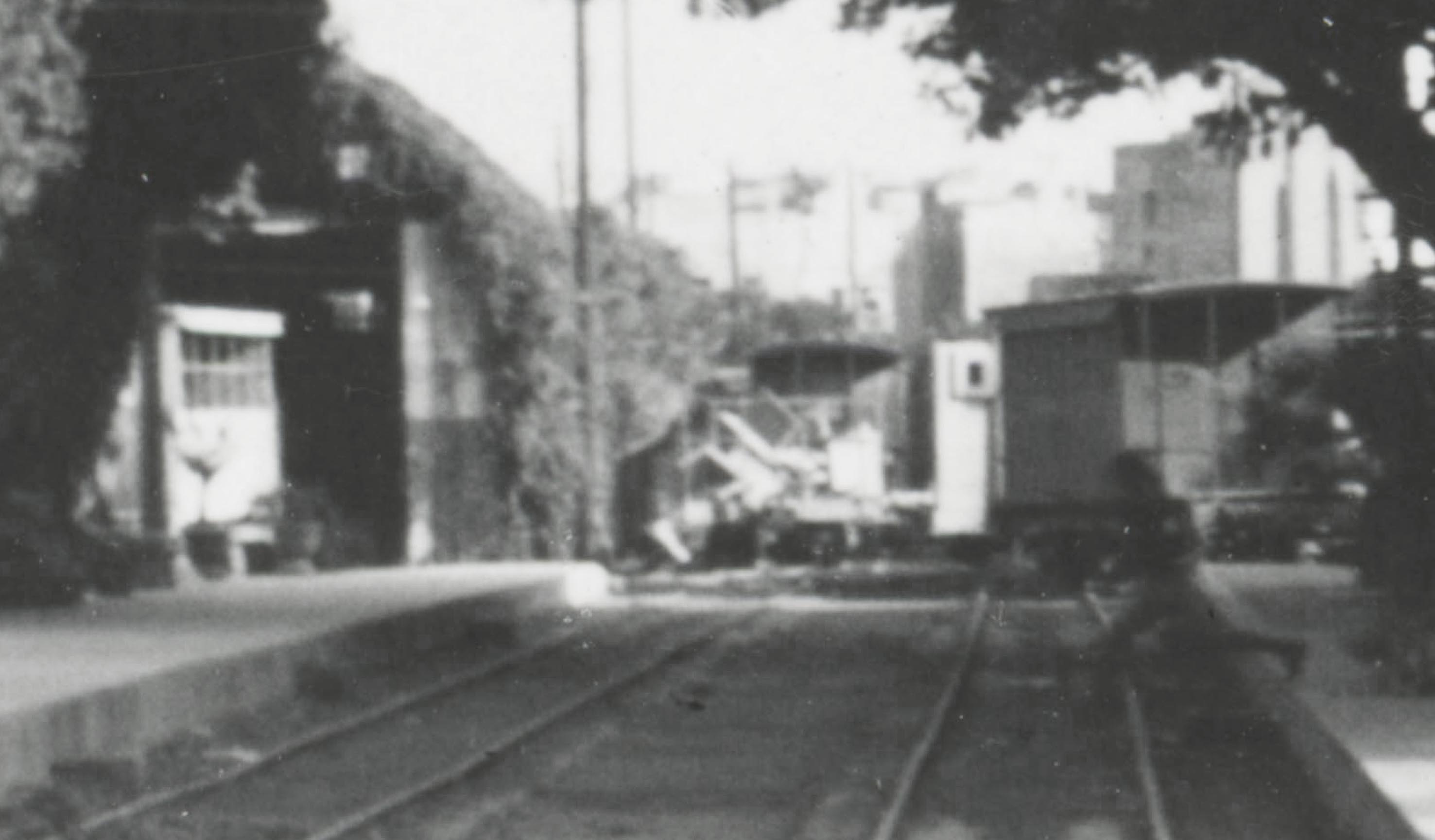 A detail of the above photo showing the abandoned  carriages at the far east end of the station. In the centre a jumbled mess of joinery is thrown onto the base of a destroyed workmen's carriage. 